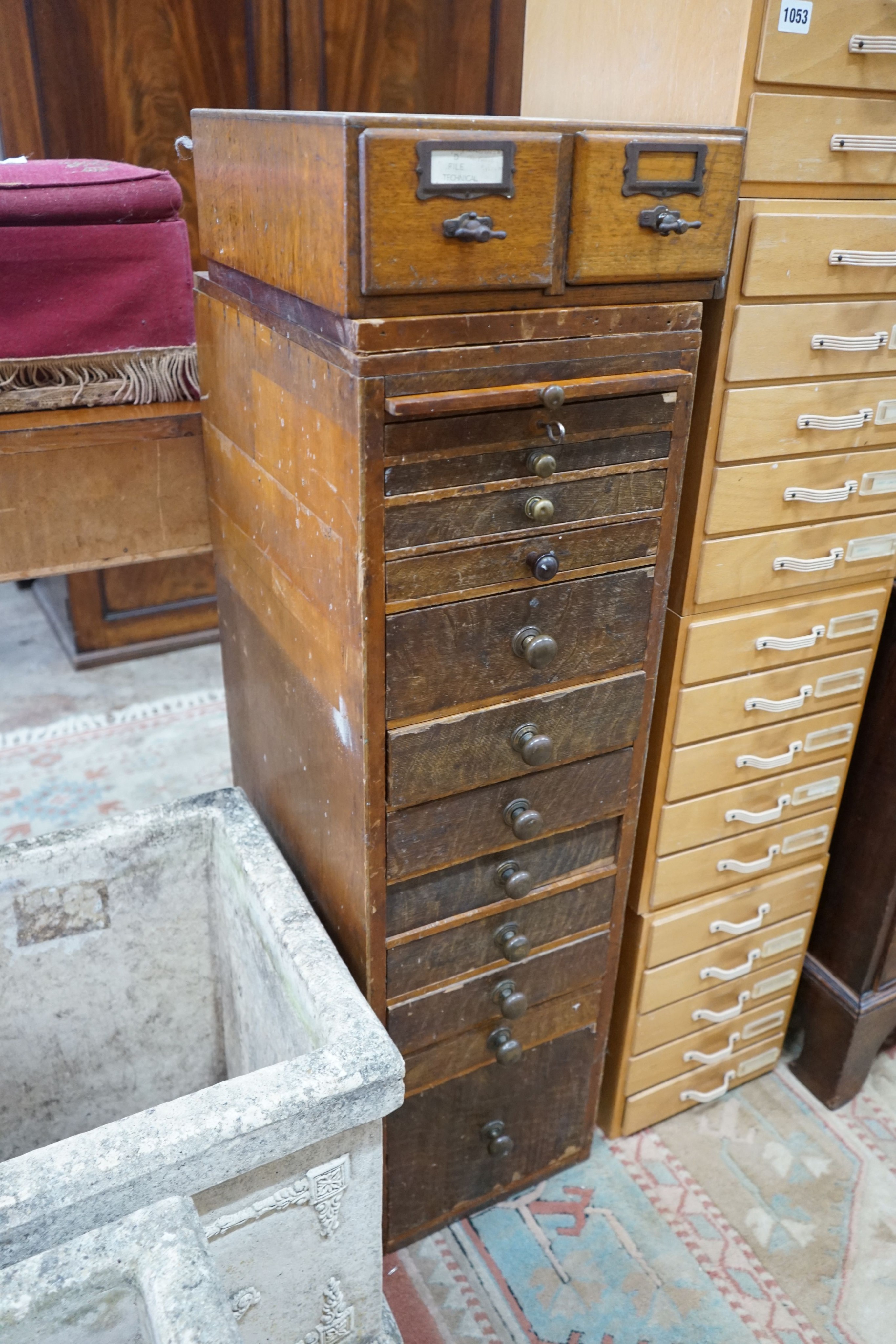 A vintage 11 drawer narrow chest containing assorted tools, height 108cm, together with an oak two drawer filing chest